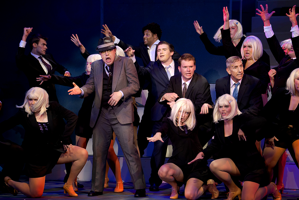 Hanratty singing in a group of Agents in a dance pose