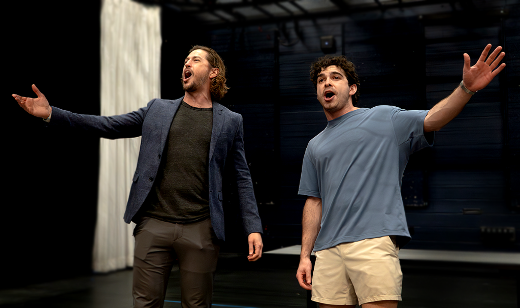two actors in a final pose of a song