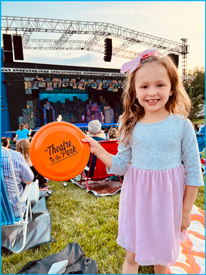 Photo of a young girl holding a frisbee at Theatre in the Park