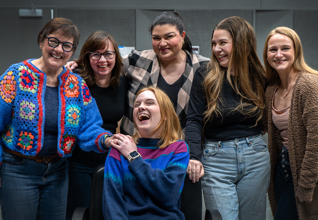 the cast of steel magnolias all in a group laughing 