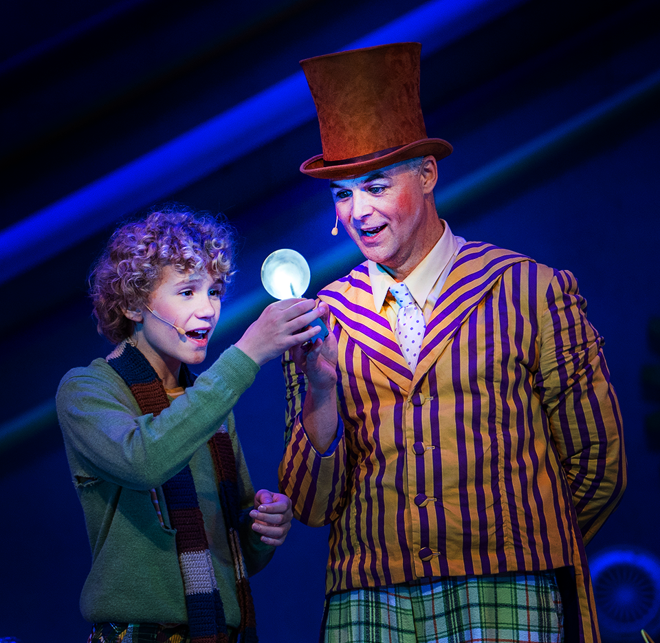 Charlie and Williy Wonka with glowing piece of candy