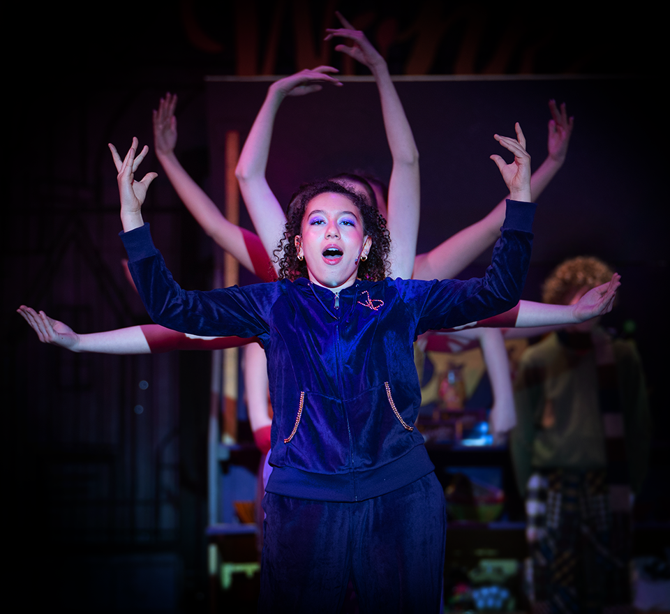 young lady in blue track suit in dancing pose