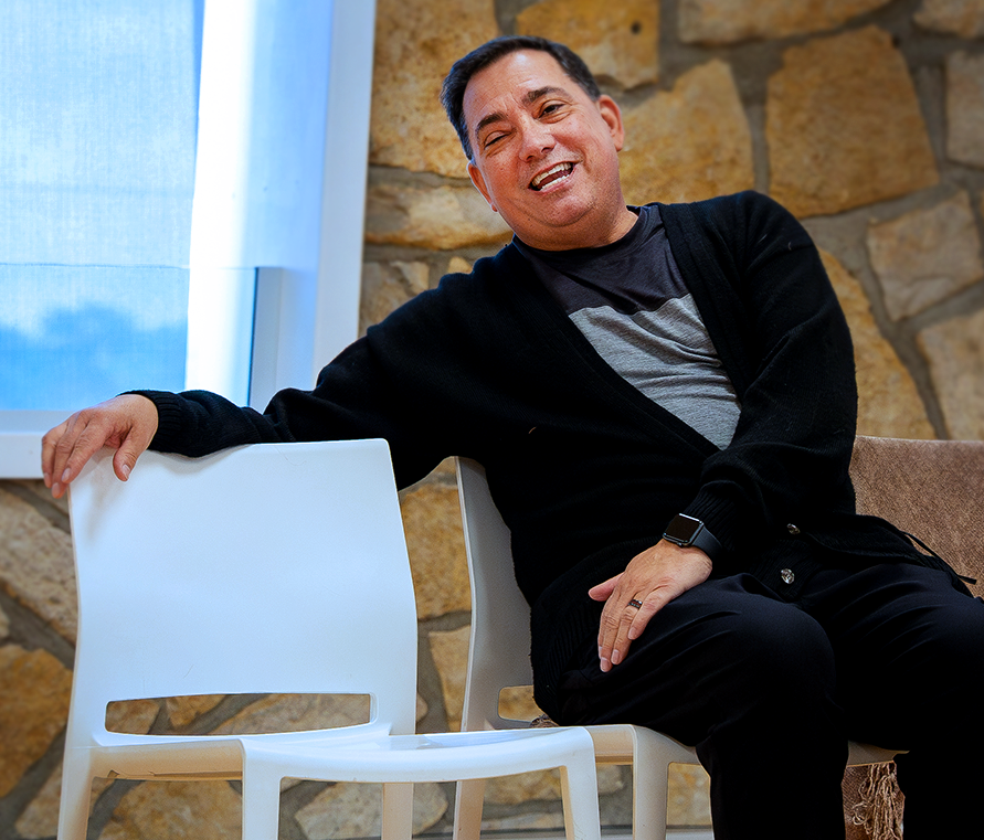 Henry higgins sitting in chair laughing