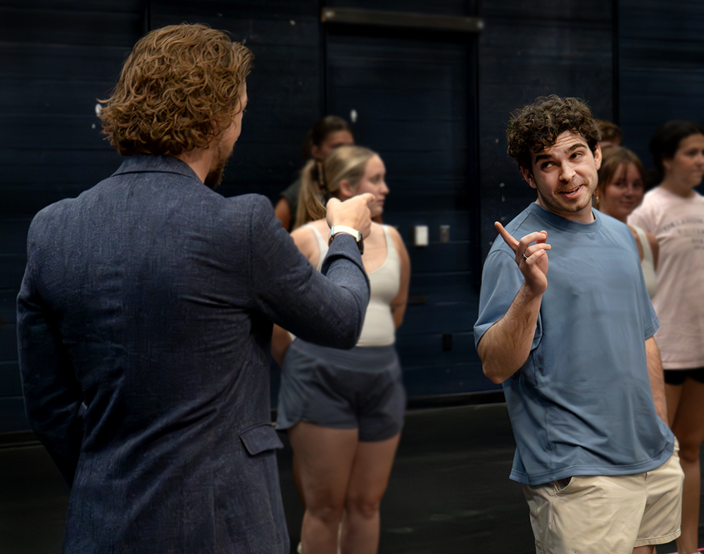 two actors singing a song and pointing at each other