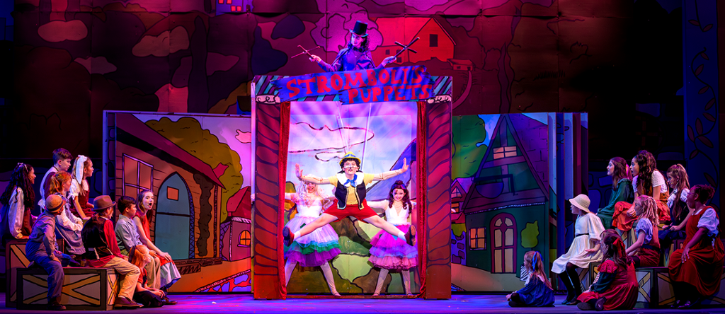 the puppets dancing in Strombolli's pupper theatre, with Pinocchio front and center