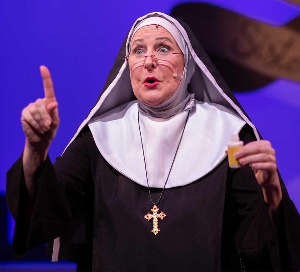 A nun telling a story and pointing toward the sky